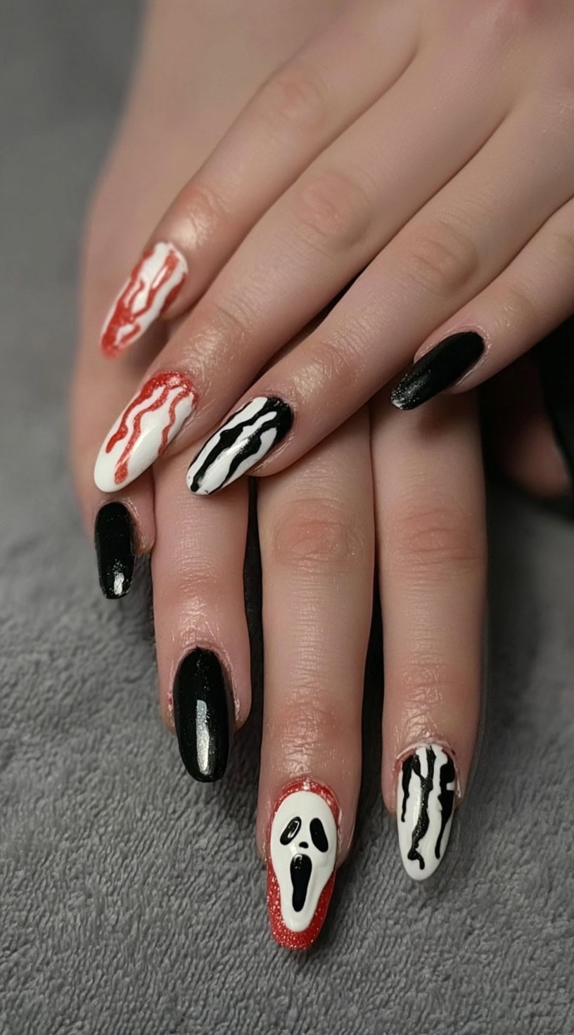 Long almond nails in black, white, and red with ghostface details and dripping blood patterns.