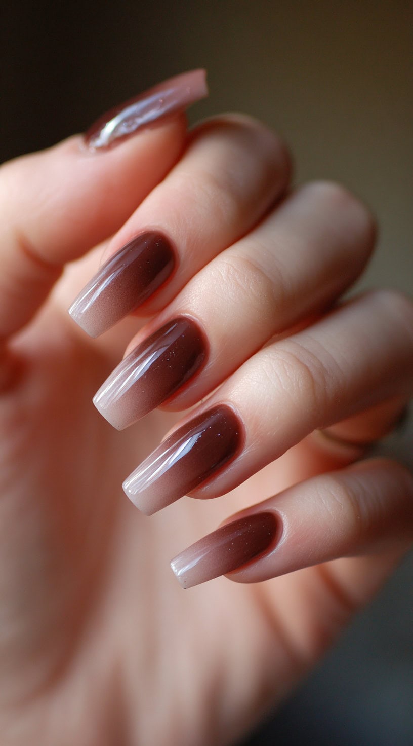 Long coffin nails with a chocolate-to-nude ombre fade and a glossy top coat.
