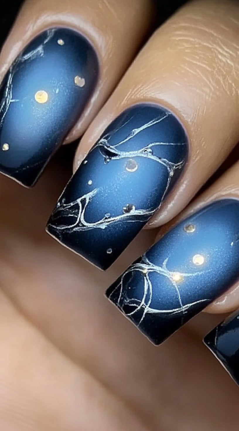 Square-shaped nails with a rich blue aura base, detailed with gold veining and soft marble textures for a luxurious finish.