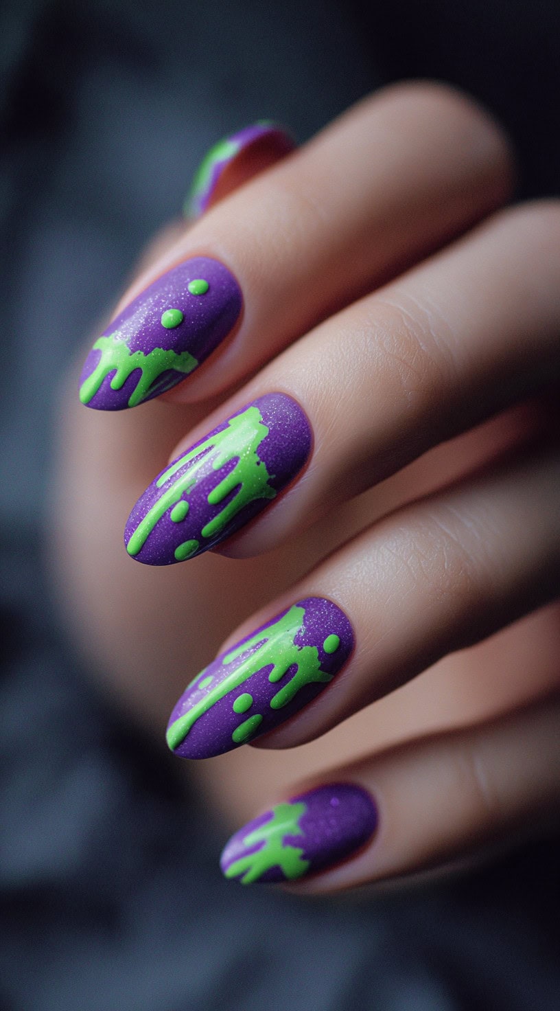 Purple almond-shaped nails with neon green drip art creating a slime effect over a matte finish.