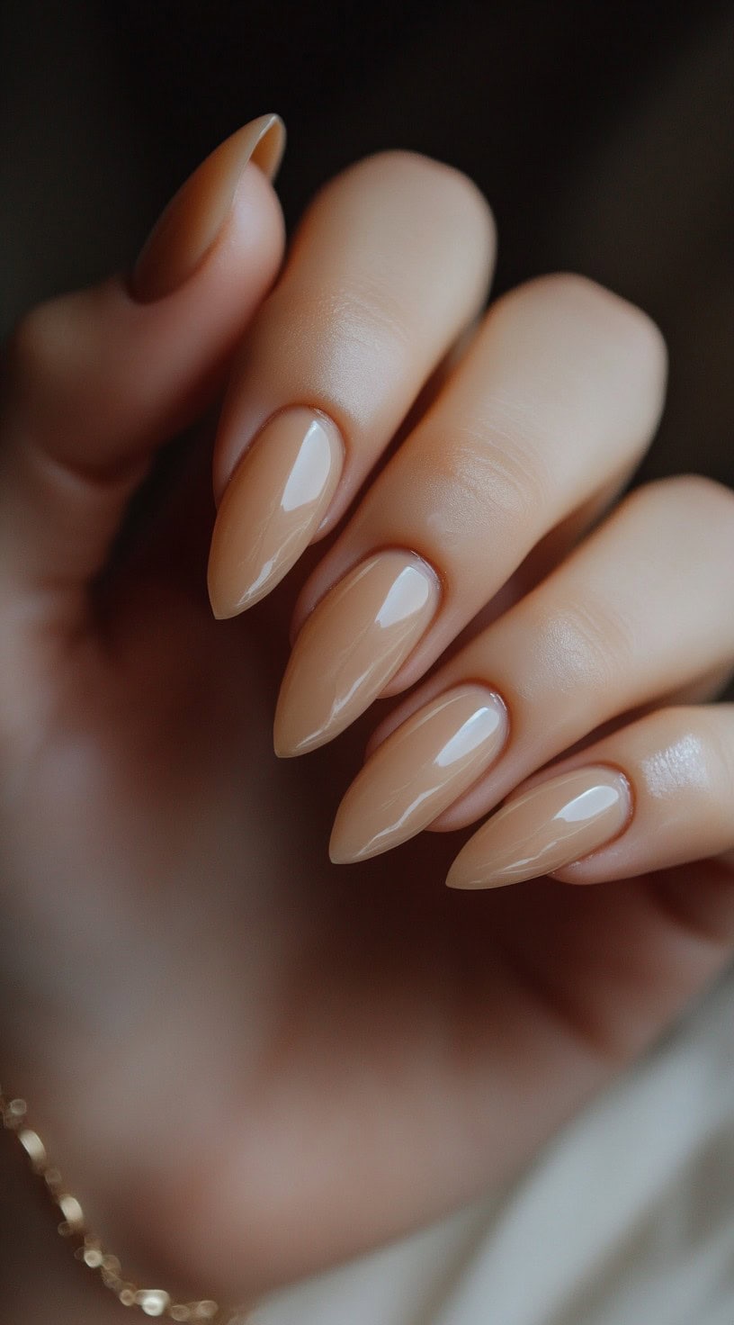 Almond-shaped nails coated in a rich, glossy caramel shade, offering a warm and sophisticated look.
