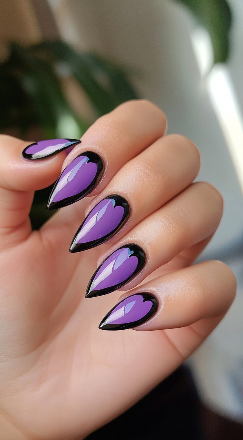 Stiletto nails with glossy purple heart shapes outlined in black.