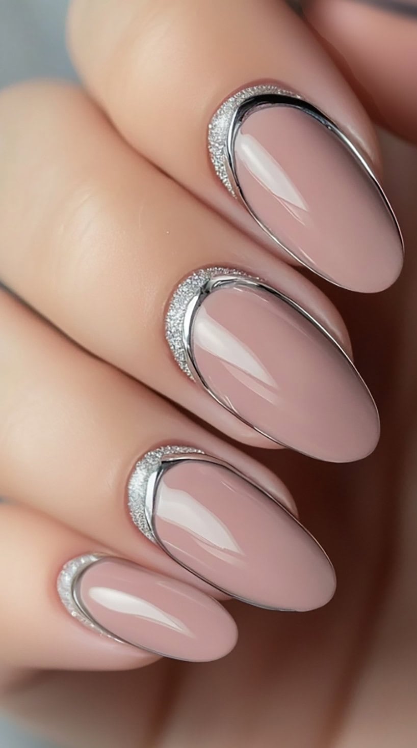 Four glossy taupe oval nails with metallic silver outlines around the base of each nail, creating a halo effect.