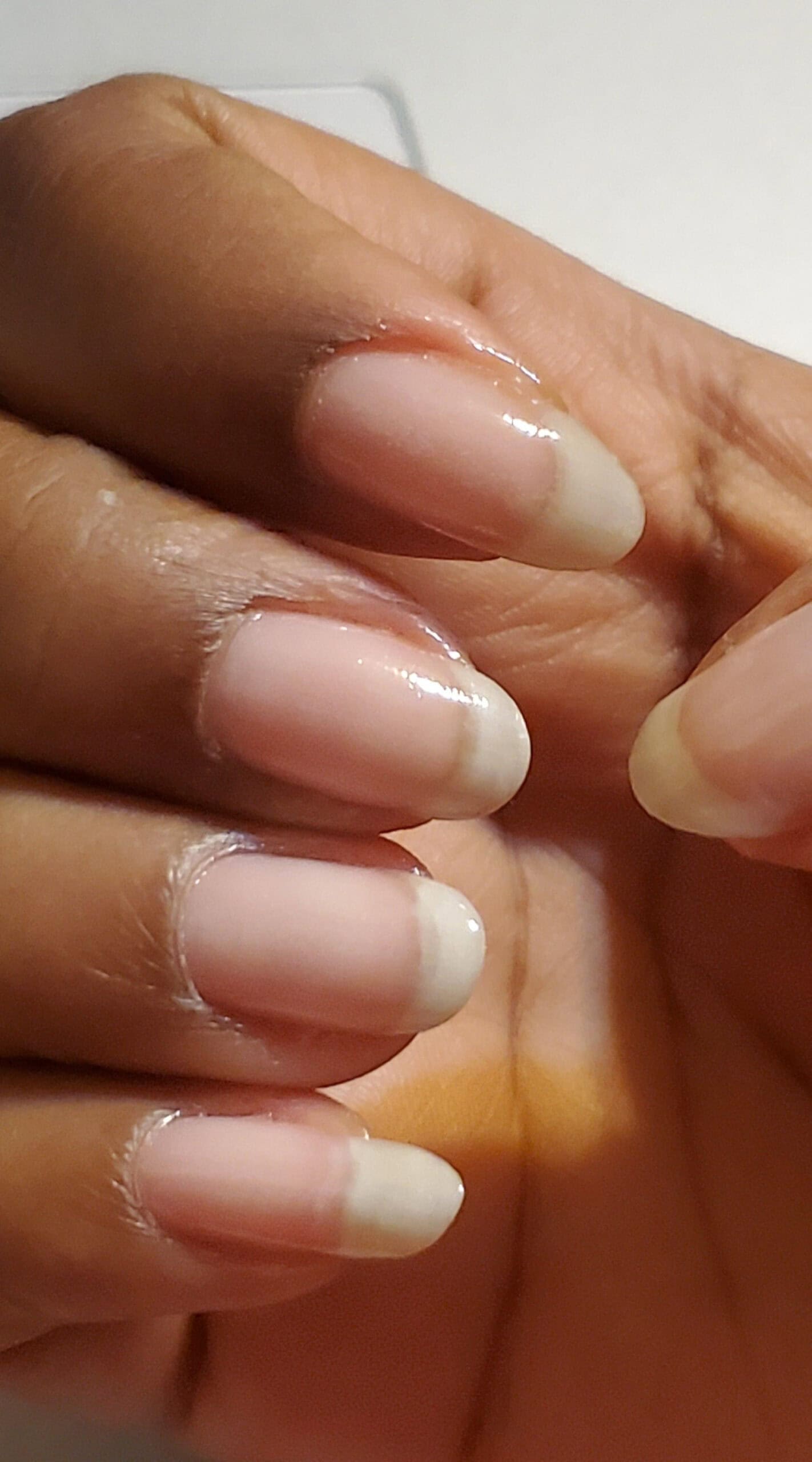 Moisturized natural nails with a healthy shine, treated with cuticle oil.