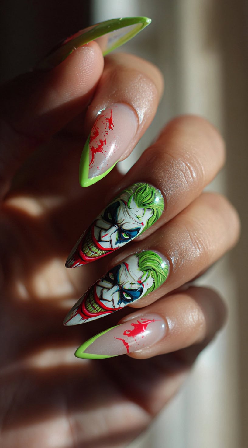 Long almond nails featuring ultra-detailed Joker portraits and neon green French tips with blood-red splatter accents.