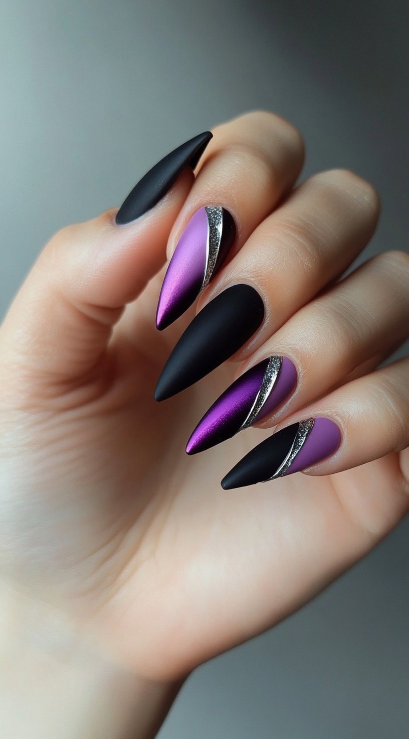 Stiletto nails featuring alternating matte black and purple chrome designs, split diagonally with silver glitter accents.