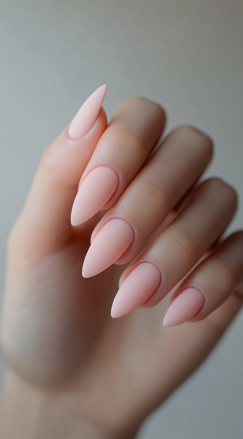 Almond-shaped nails with a soft matte blush pink polish for a velvety, elegant look.