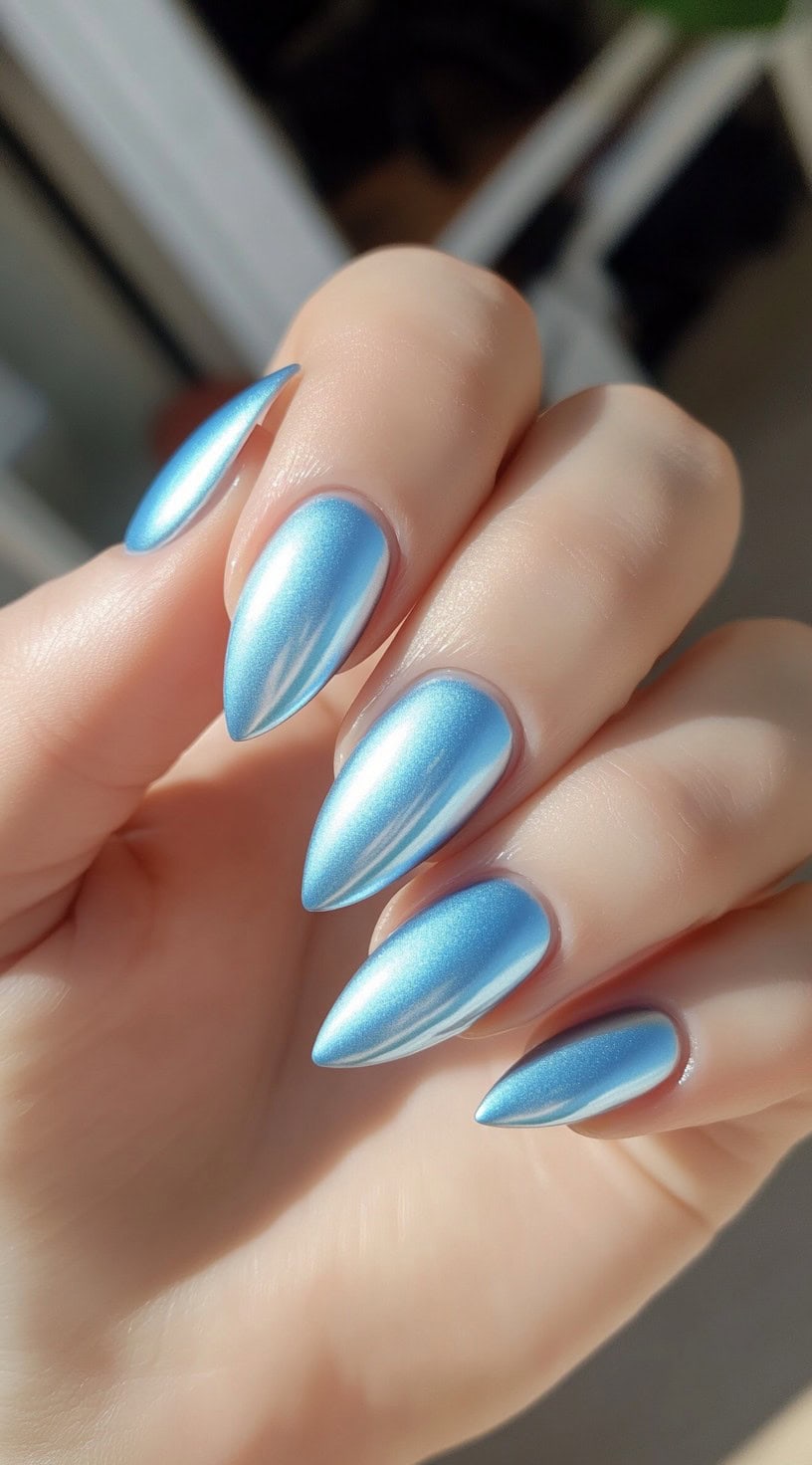 Metallic light blue almond nails with a glossy, reflective finish.
