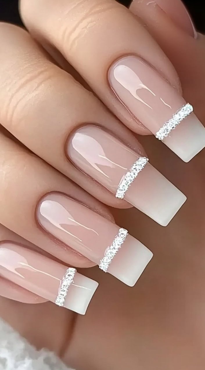Square-shaped French nails featuring a sheer pink base, straight-cut white tips, and a thin line of sparkling silver glitter across the middle.