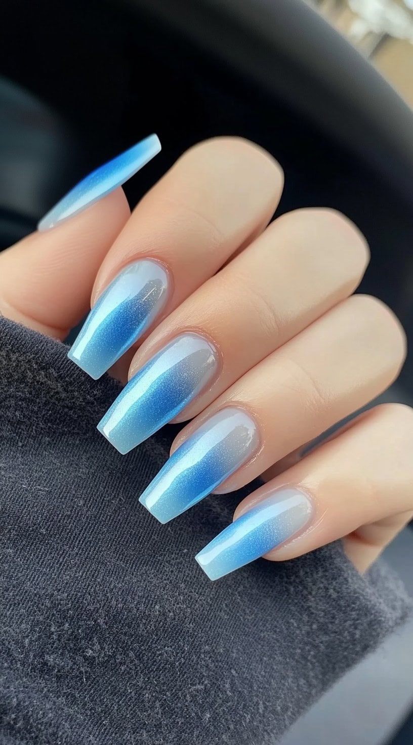 Coffin-shaped nails featuring a soft misty blue aura ombré with a pearlescent shimmer.