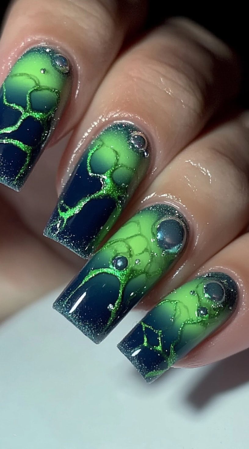 Long square nails featuring a glowing neon green jelly effect blending into deep blue with raised bubble details.