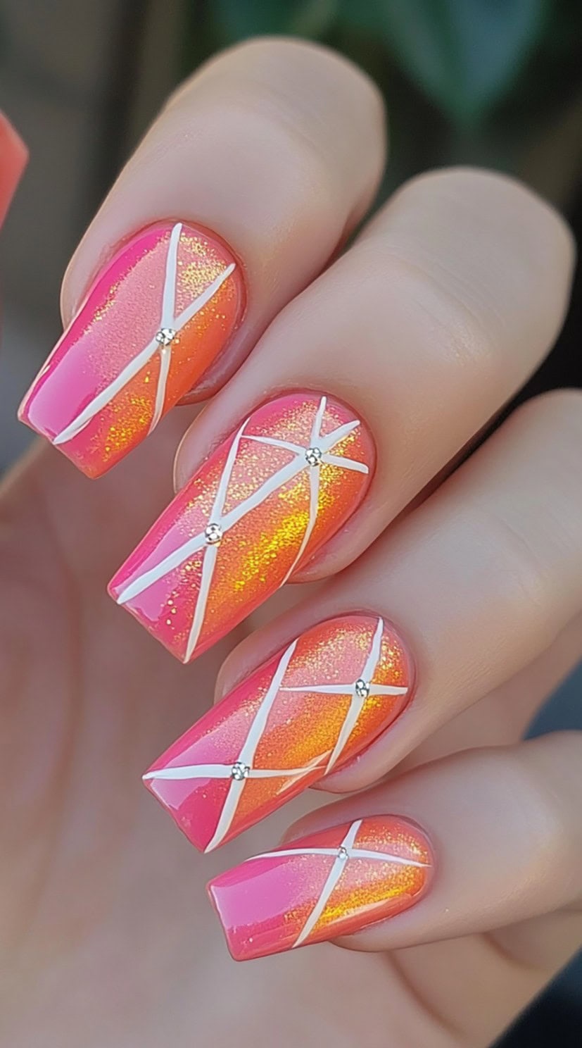 Square nails in a vibrant pink-orange gradient with white crisscross lines and tiny rhinestones at intersections.
