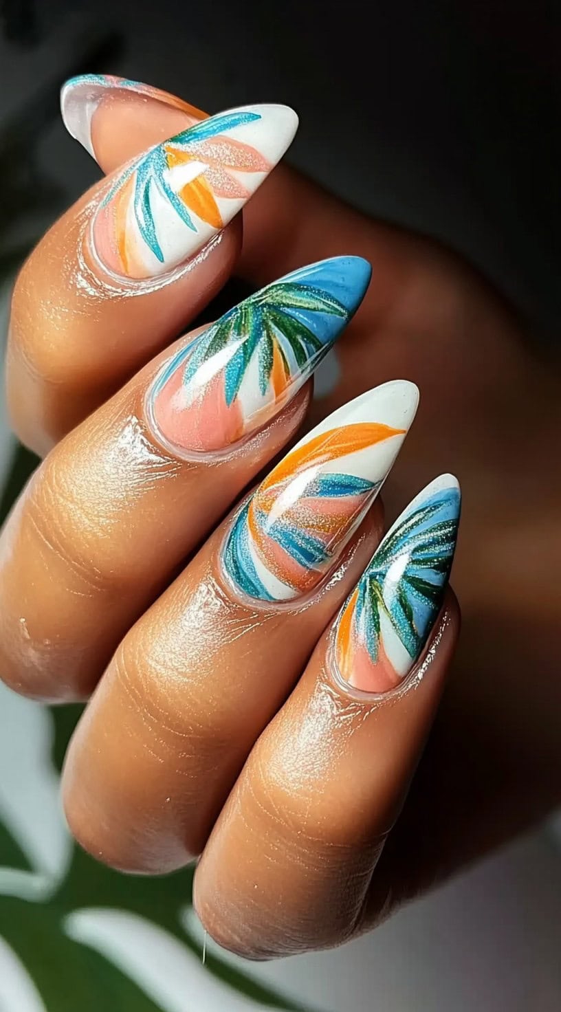 Almond-shaped nails with a white base, featuring abstract palm leaf patterns in blue, green, and orange shades.