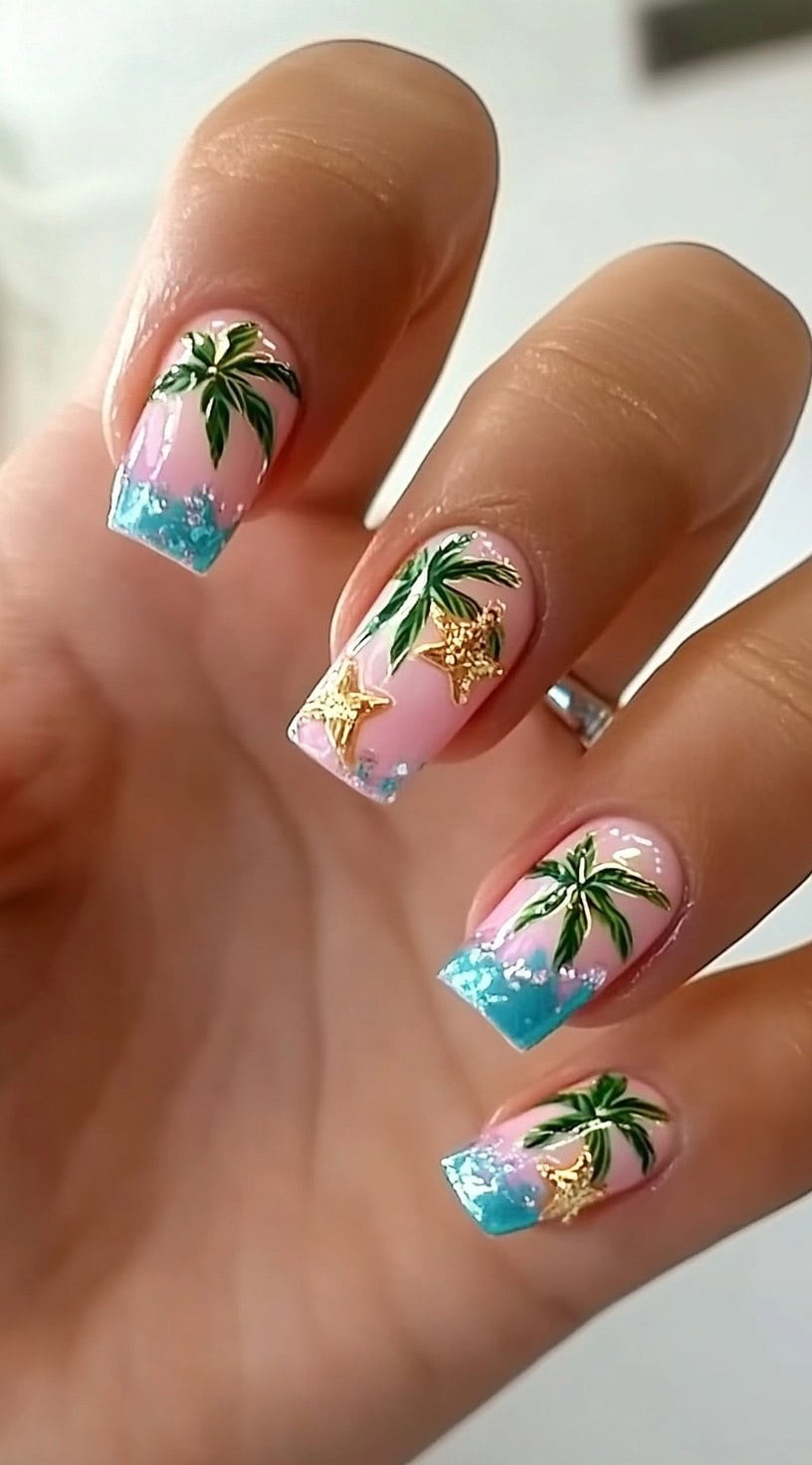 Square nails with pink base, blue ocean tips, palm tree accents, and gold starfish charms.