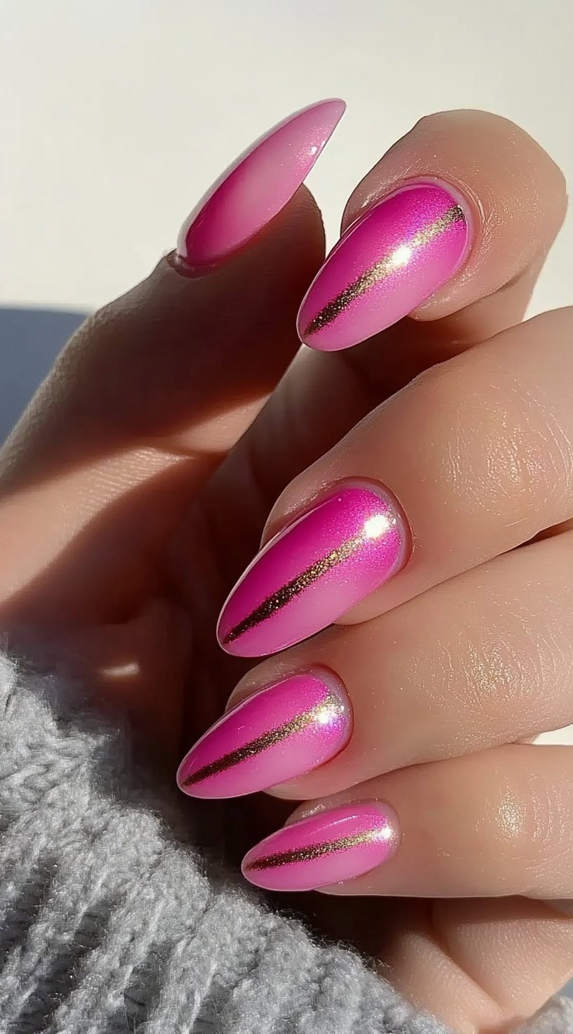 Almond-shaped nails with a reflective pink chrome aura effect, enhanced by sleek metallic gold lines.