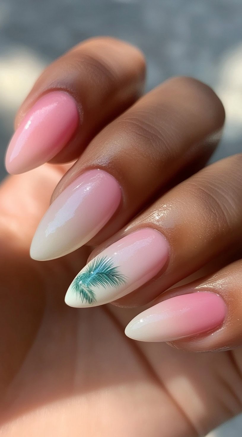 Almond-shaped nails featuring a pink ombre effect with a realistic palm tree design on one accent nail.