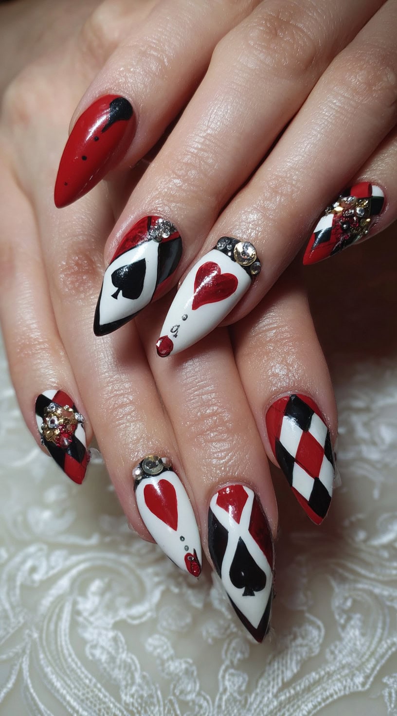 Almond nails with red, black, and white card suit designs, gem accents, and argyle patterns.