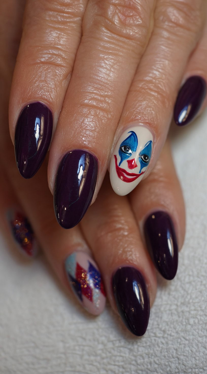 Almond-shaped nails painted deep purple with a single accent nail depicting Joker's clown makeup on a pale base.