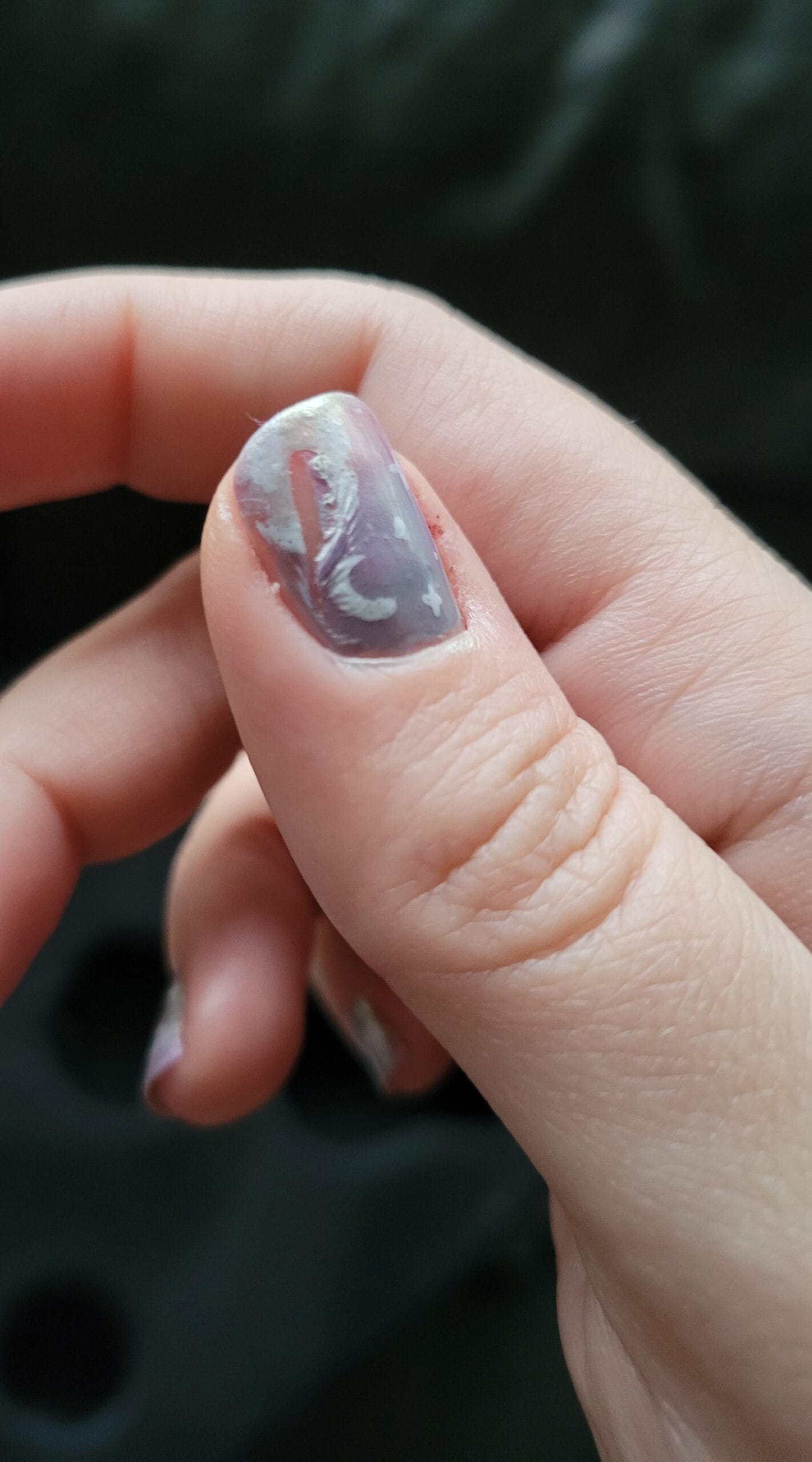 Nail art design with a light purple base showing heavy smearing and distorted patterns.