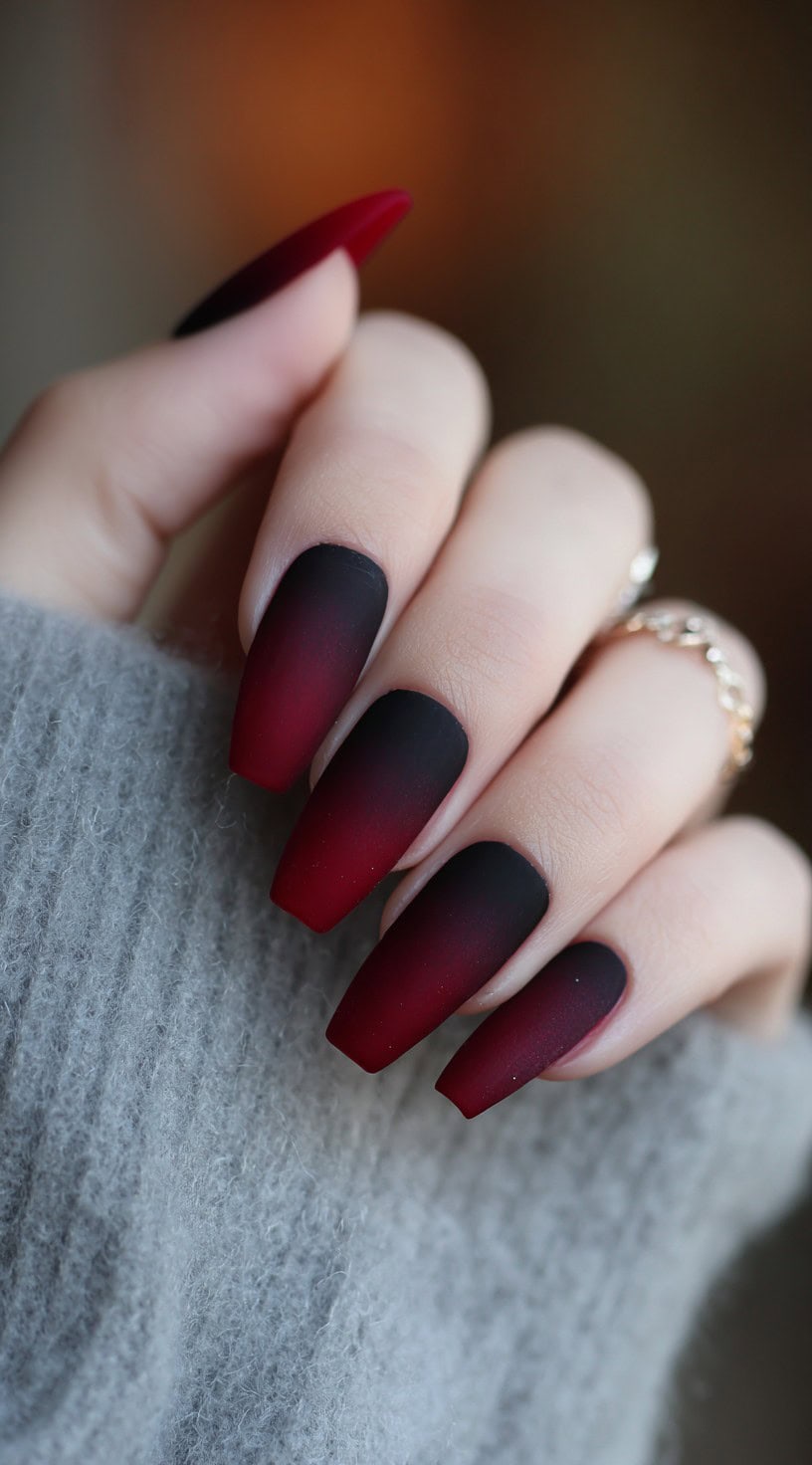 Medium coffin-shaped nails with a seamless matte gradient from deep burgundy to black.