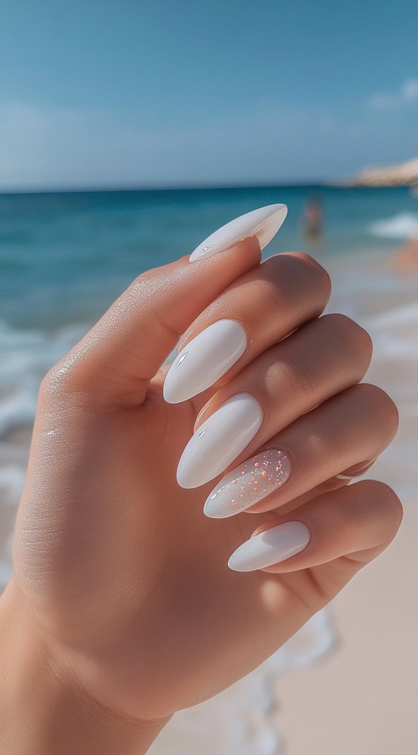 Almond-shaped nails painted with a pure white glossy finish, featuring a glitter accent nail with subtle peach sparkles.